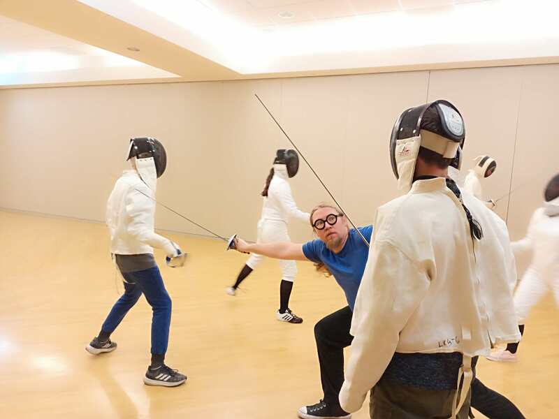 victor demonstrating lunge to students in class